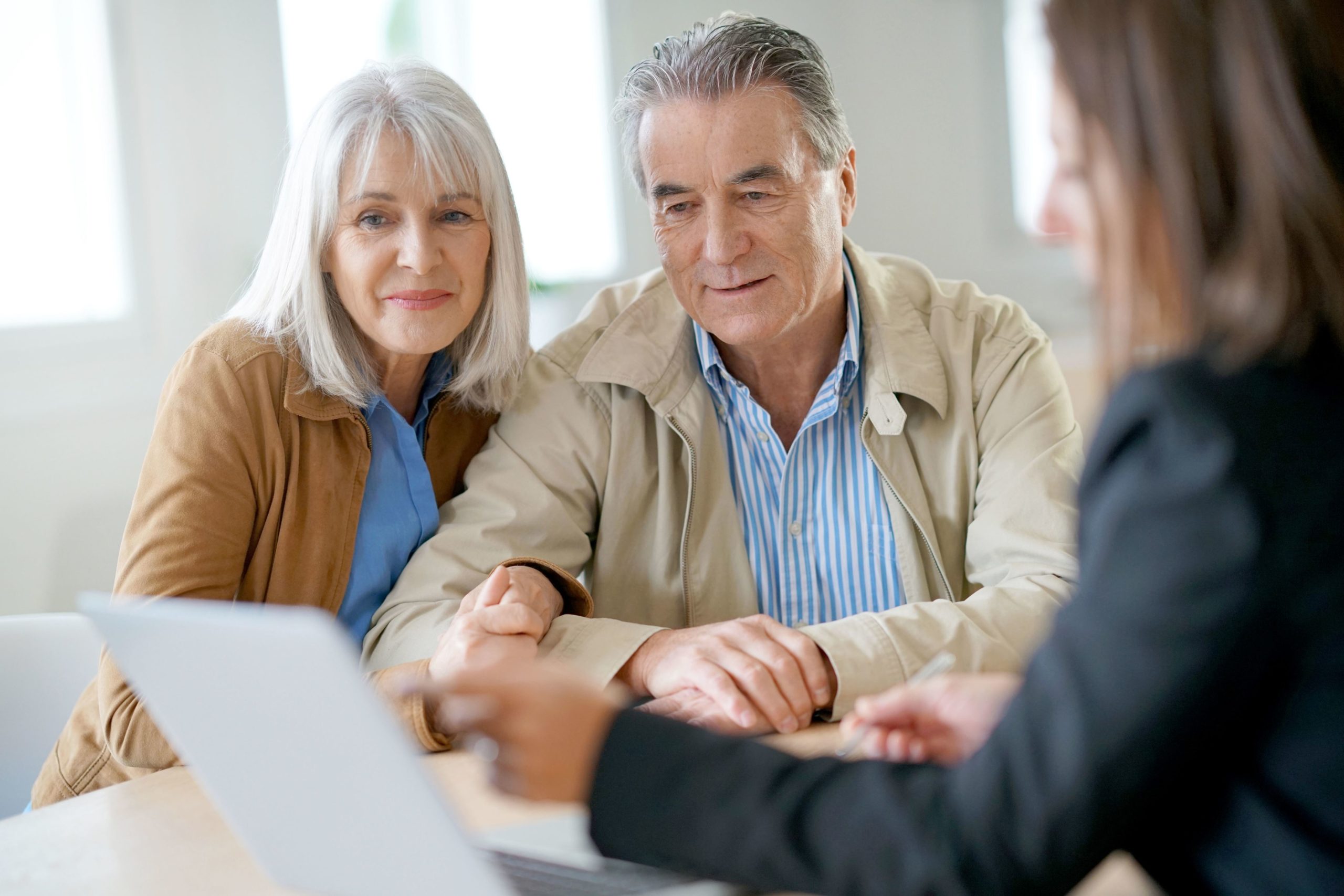 Senior couple meeting financial adviser for investment